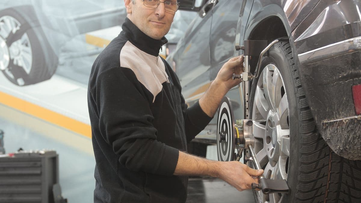 Technician inspecting an alloy wheel for repair quality at Speedline Mags in Parow, Cape Town