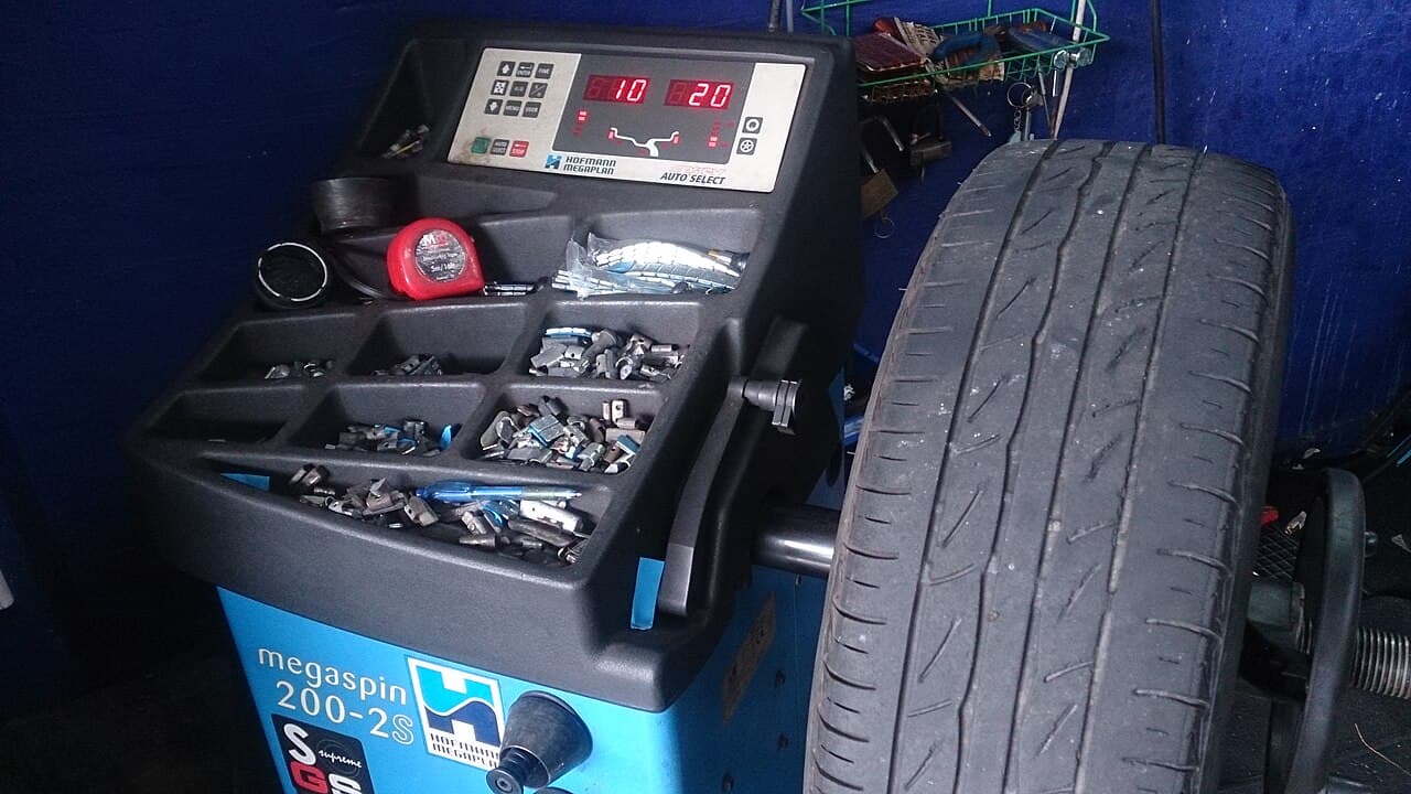 Wheel balancing machine spinning a mounted tyre after rim repair at Speedline Mags