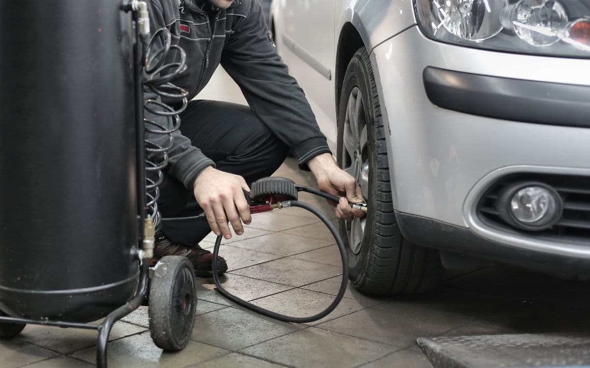 Technician inspecting a damaged alloy wheel for a wheel damage insurance claim at Speedline Mags in Cape Town